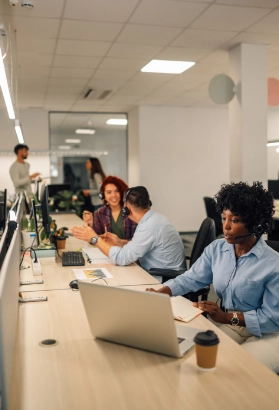 A customer support agents sitting at call center and talking to clients.
